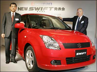 Suzuki Motor Co President Hiroshi Tsuda (L) and Chairman Osamu Suzuki introduce the new sporty hatchback Swift, equipped with a 1.3 or 1.5 liter engine at a Tokyo hotel November 1, 2004. Suzuki's global strategic car Swift will be produced in India, China, Hungary, and Japan. Photo: Yoshikazu Tsuno/AFP/Getty Images