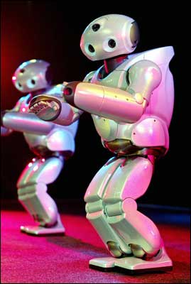 'Qrio' entertainment robots from Japanese electronics giant Sony, give a dance performance on stage at the Sony showroom in Tokyo. Sony's humanoid robots, 58cm in height and weighing 7kg, have three CPUs and 38 micro actuators to help them move smoothly. Photo: Yoshikazu Tsuno/AFP/Getty Images