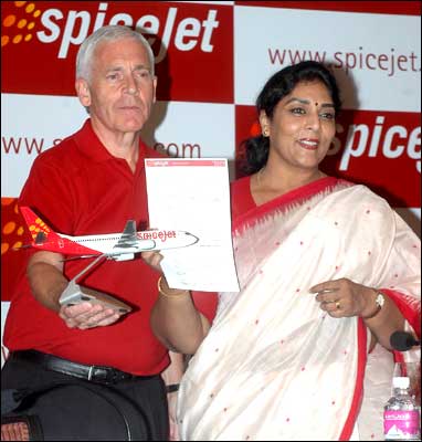 Tourism Minister Renuka Chaudhury shows the first e-ticket issued by newly launched low-cost air carrier Spicejet in New Delhi on Tuesday. To her right is Mark Winders, CEO of Spicejet. Photograph: Ranjan Basu/ Saab Pictures