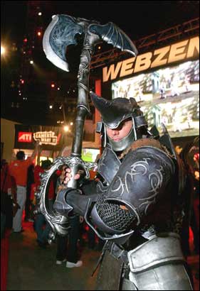 An actor portraying a Webzen game character strikes a menacing pose -- or perhaps 'batter up' -- at the Electronic Entertainment Expo in Los Angeles. AP Photo/Reed Saxon