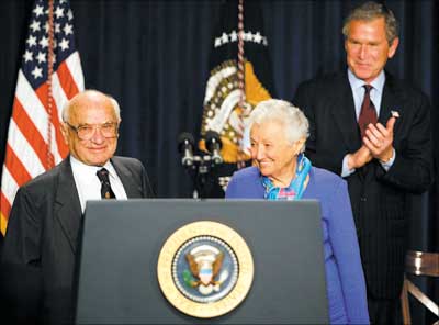 US President George W Bush honours Milton Friedman (L), the recipient of the 1976 Nobel Memorial Prize for Economic Science, on the occasion of his 90th birthday. Also seen is the Nobel laureate's wife Rose Friedman (C) during a tribute on May 9, 2002 in Washington, DC. Photograph: Tim Sloan/AFP/Getty Images