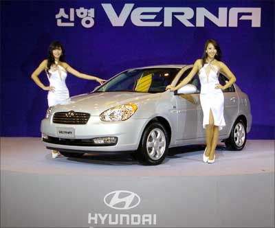 South Korean models pose next to Hyundai Motors' new Verna. Photograph: Kim Jae-Hwan/AFP/Getty Images