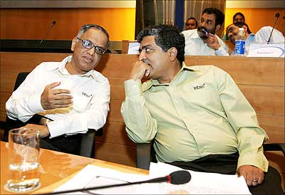 Infosys chief mentor and chairman N R Narayana Murthy (L) and current chief executive officer Nandan Nilekani discuss a point during a press conference in Bangalore on Friday. Nilekani will be co-chairman of the company from June 22, while S 'Kris' Gopalakrishnan will be the new Infy CEO. Photograph: Dibyangshu Sarkar/AFP/Getty Images