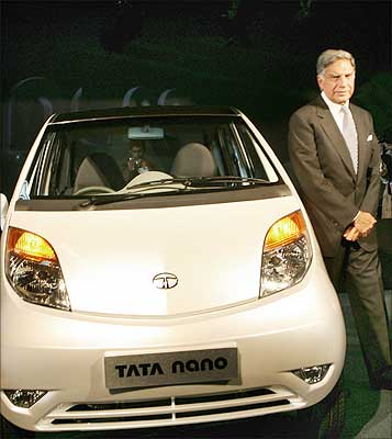 Tata Group chairman Ratan Tata poses with the Tata 'Nano' car during the launch of the world's cheapest car at $2,500 or Rs 1 lakh, in New Delhi, on January 10. Photograph: Raveendran/AFP/Getty Images