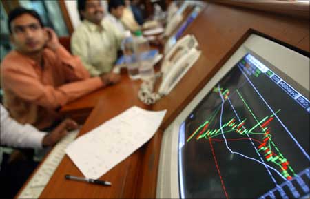Indian stock brokers watch the key Sensex share index graph at a brokerage firm in Mumbai.
