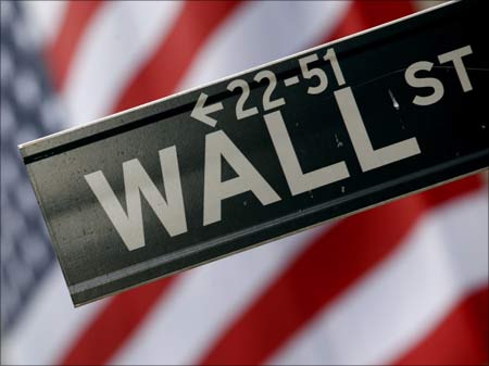 A street sign is seen in front of the New York Stock Exchange on Wall Street in New York.