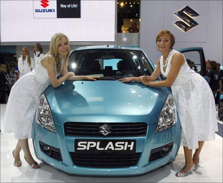Models pose next to the new Splash (or Ritz) of Japanese car manufacturer Suzuki
