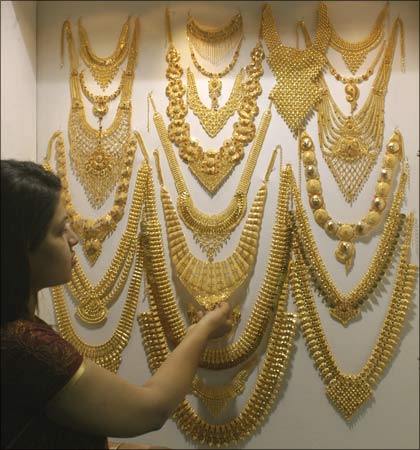 A visitor admires a gold necklace on display at the Gem & Jewellery India International Exhibition 2009 in Chennai.
