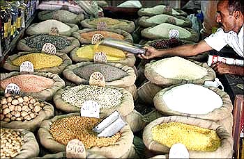 An Indian shopkeeper sells pulses.