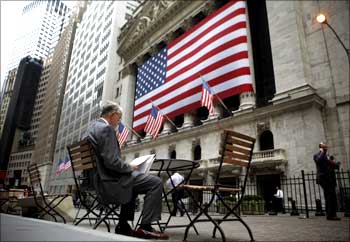 A man reads outside the New York Stock Exchange.