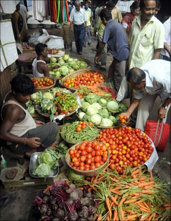 Customers purchase vegetables at a wholesale market in Agartala.