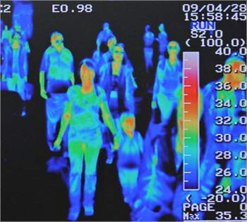 A thermal scanner shows the heat signature of passengers from an international flight.