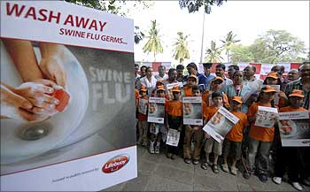 Children hold placards as they take part in a swine flu awareness rally in Hyderabad.