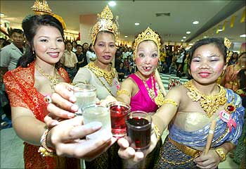 Contestants pose during a drinking competition for women at a mall in Bangkok.