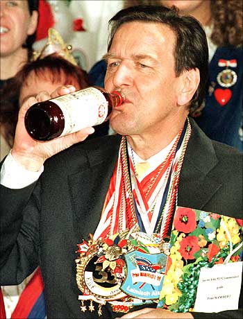 Ex-German Chancellor Gerhard Schroeder tries some herbal liqueur from the Eifel region.