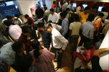 Investors crowd a Reliance counter to submit subscription forms for buying the initial public offering (IPO) of Reliance Power in Mumbai in January 2008.