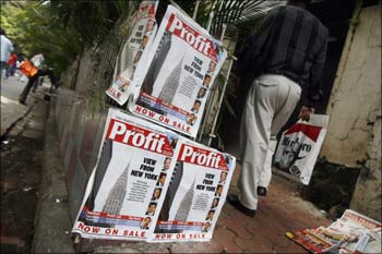 A man walks past advertisements for an Indian business magazine in Mumbai.