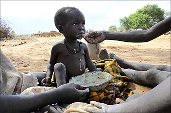 A malnourished child is fed a meal in Uganda's Karamoja region.