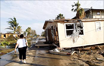 A resident walks next to a damaged house after Hurricane Ike hit the Golf of Mexico in in September, 2008.
