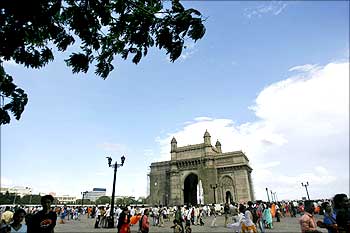 People stroll along the seafront near the Gateway of India in Mumbai.