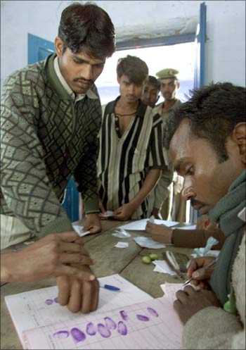 A voter registers his vote using his fingerprint.