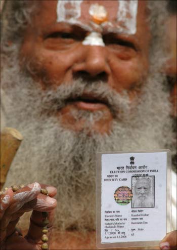 A voter displays his identity card.