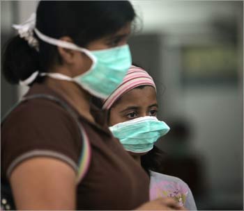 People wearing surgical masks wait for a H1N1 flu screening at Ram Manohar Lohia Hospital in New Delhi. 