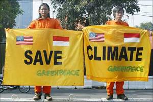 Greenpeace activists hold a banner urging world leaders to save the climate