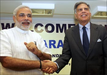 Tata Group chairman Ratan Tata (R) shakes hands with Gujarat's Chief Minister Narendra Modi in Gandhinagar.