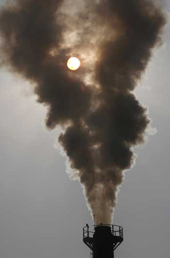 Smoke rises from a chimney of a garbage processing plant at Daddumajra village near Chandigarh.