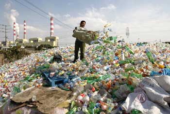 A worker dumps plastic bottles at a recycling centre in Ningbo, Zhejiang province, China.