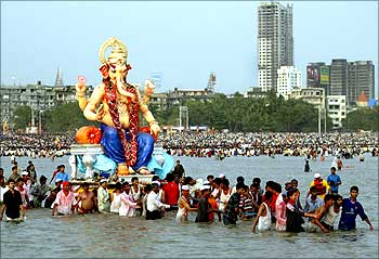 Devotees carry a statue of elephant headed god Ganesh for its immersion into the Arabian Sea in Mumbai.