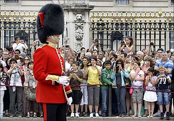 Tourists take pictures of the Changing of the Guard Ceremony at Buckingham Palace in central London.