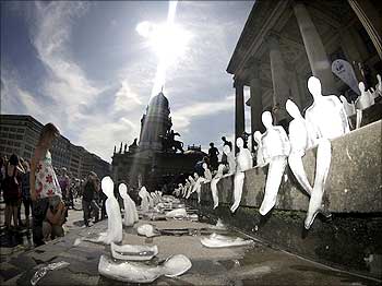Ice sculptures in the shape of humans are placed on the steps of the music hall in Gendarmenmarkt public square in Berlin.