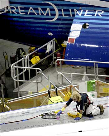 A Boeing worker works on the wing of a 787 Dreamliner.