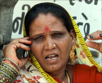 A woman talks on aa mobile phone.