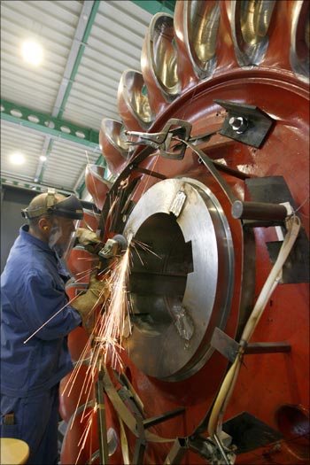 A worker grinds the wheel of a turbine at a plant of Grimsel Hydro.