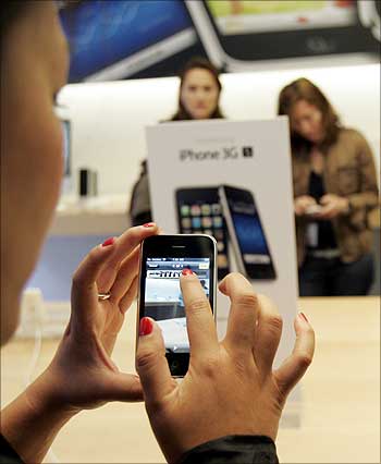 A customer tries the Apple iPhone 3GS at the company's retail store in San Francisco.