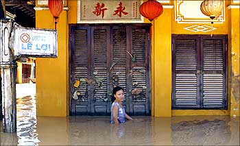 A woman wades through flood waters caused by Typhoon Ketsana in Vietnam.
