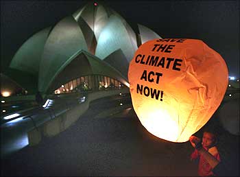 A sky lantern floats in front of the Bahai Mashriqu'l-Adhkar, or the Lotus Temple, during an environment awareness programme in New Delhi.