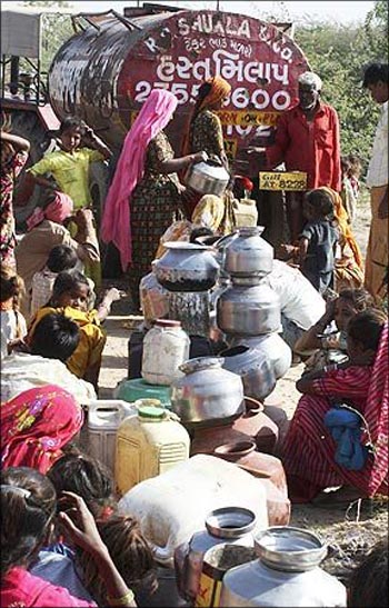 People crowd around a water-tanker in Ahmedabad.