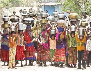 Women carry pitchers filled with drinking water at Siyani village, near Ahmedabad.