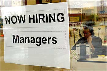A hiring sign hangs in a window in Virginia.