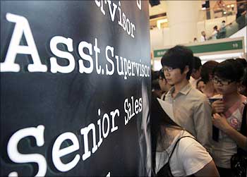 Job seekers wait in line at a job fair, in which 3,700 jobs vacancies are offered, in Hong Kong.