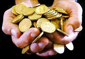 A handful of gold dollar coins.