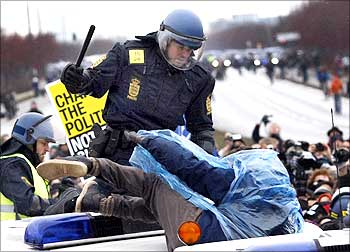 A police officer beats a protester at a road block during a demonstration outside the United Nations Climate Change Conference 2009 in Copenhagen on Wednesday.
