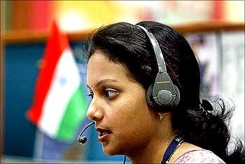 Indian employee at call centre provides international customer support in Bangalore.