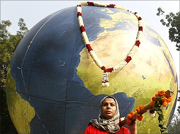 A Greenpeace activist protesting against climate change carries a model of the earth during a mock funeral procession in New Delhi.