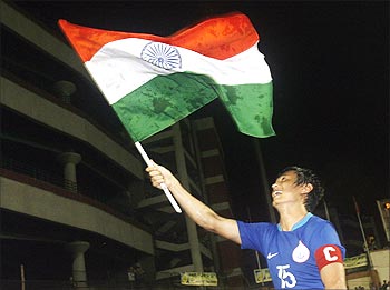 Indian flag flies high: India's soccer captain Bhaichung Bhutia holds the national flag as he celebrates his team's victory over Syria in the final of ONGC Nehru Cup.