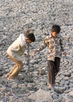 A child digs up parched land in search of water in Bagha Nseda village, Gujarat.